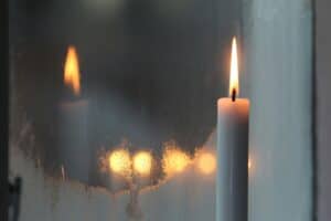 Candle reflected in window